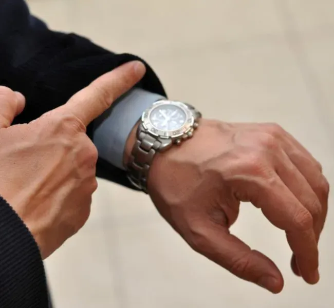 Escort client checks the time to ensure punctuality for the escort date